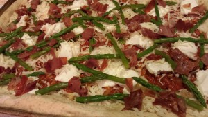 Arrange the asparagus around the pizza (Photo Credit: Adroit Ideals)