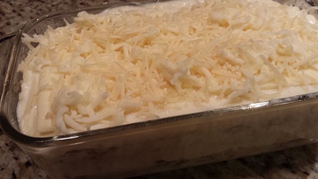 Add the rest of the shredded mozzarella and shredded Parmesan to the top.   (Photo Credit: Adroit Ideals)