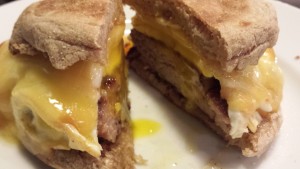 Hearty Breakfast Sandwich: Sausage, Smoked Gouda, and Fried Egg on a Buttered Toasted English Muffin (Photo Credit: Adroit Ideals)