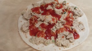 Drizzle some enchilada sauce over the chicken filling  (Photo Credit: Adroit Ideals)