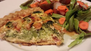 A slice of Broccoli, Ham, and Smoked Gouda Quiche along with a Garden Salad (Photo Credit: Adroit Ideals)