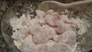 Coat the chicken cubes with the seasoned flour (Photo Credit: Adroit Ideals)