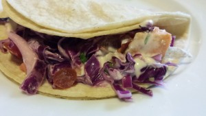 Salmon Fish Taco with Shredded Purple Cabbage, Pico de Gallo, and Chipotle Cream Dressing (Photo Credit: Adroit Ideals)