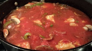 Add the crushed tomatoes and simmer the sauce (Photo Credit: Adroit Ideals)
