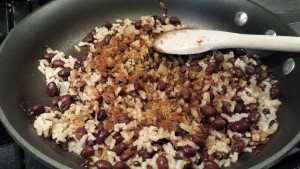 Add the beans, rice, chili powder, and cumin and stir (Photo Credit: Adroit Ideals)