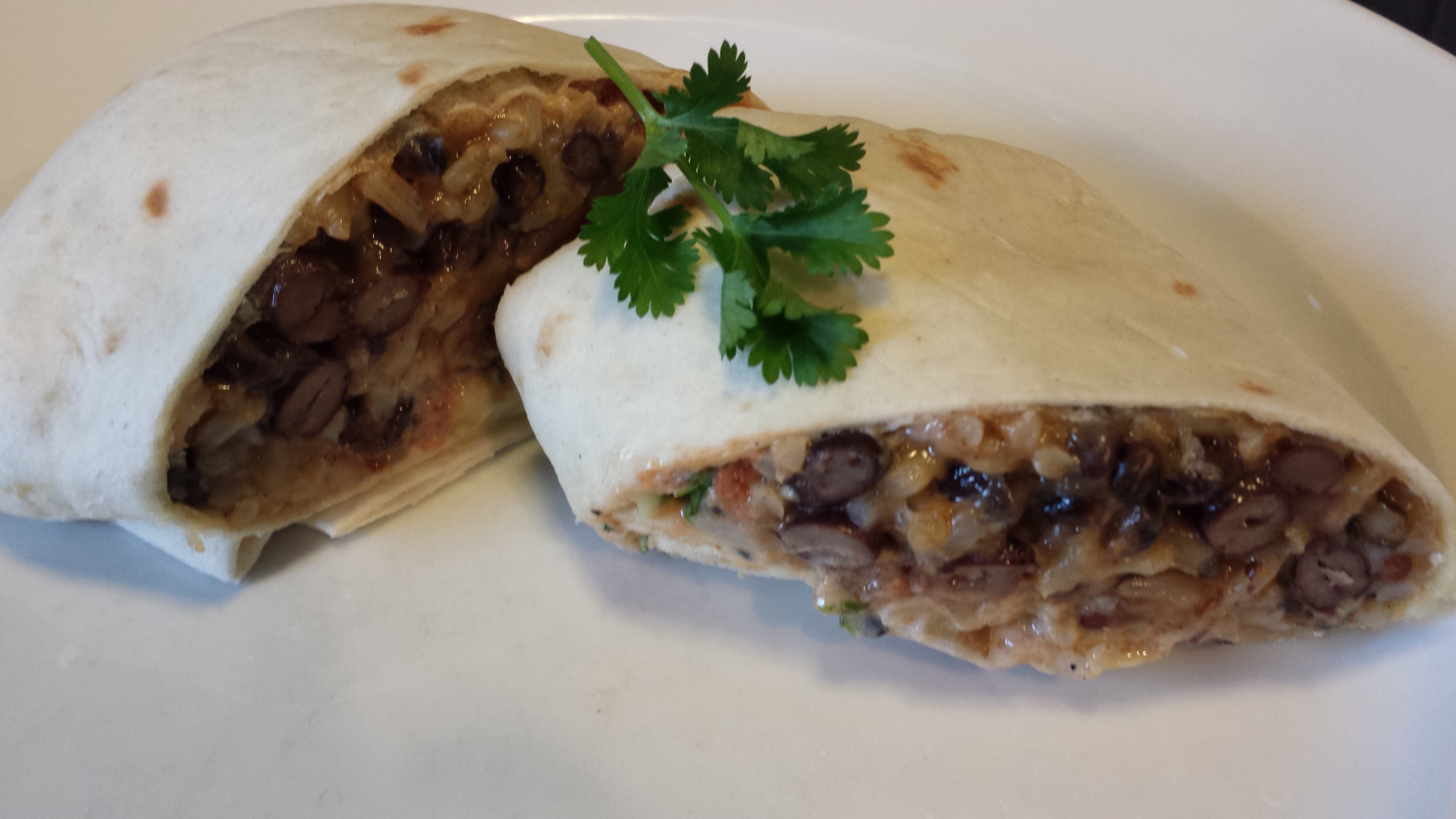Black Bean Brown Rice Burrito with Cheeses, Homemade Salsa, Chipotle Cream Dressing, and Cilantro (Photo Credit: Adroit Ideals)
