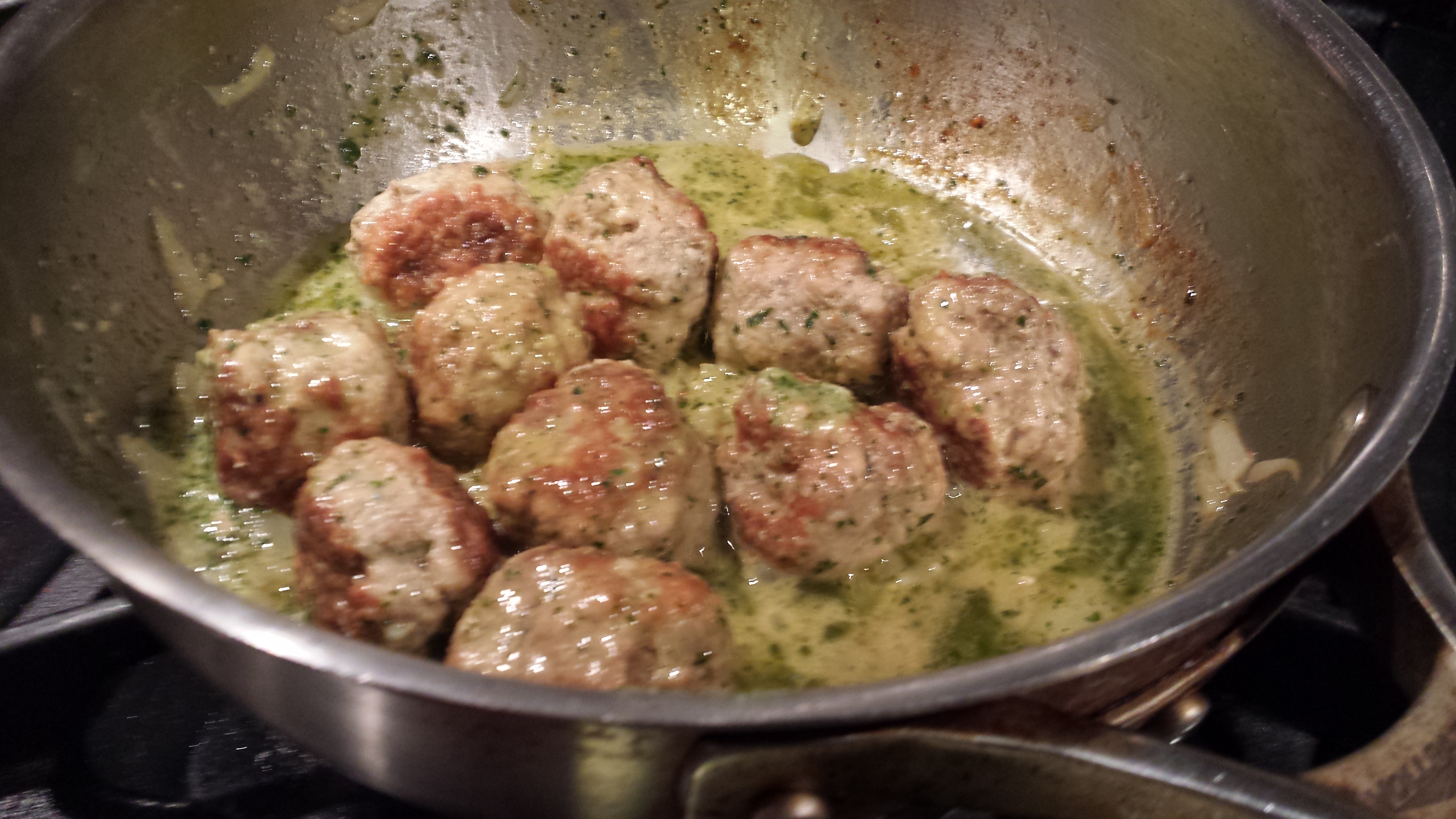 Stir the meatballs and the pesto (Photo Credit: Adroit Ideals)