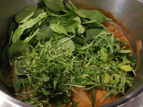 Add spinach, arugula, pea shoots