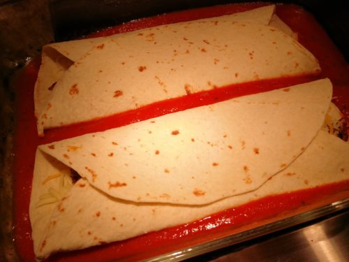 Fold enchiladas and place in pan