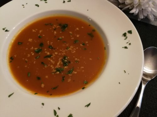 Soup garnished with walnuts and parsley
