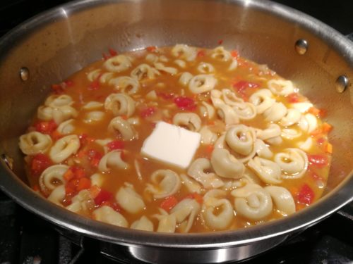 Add tortellini and pat of butter