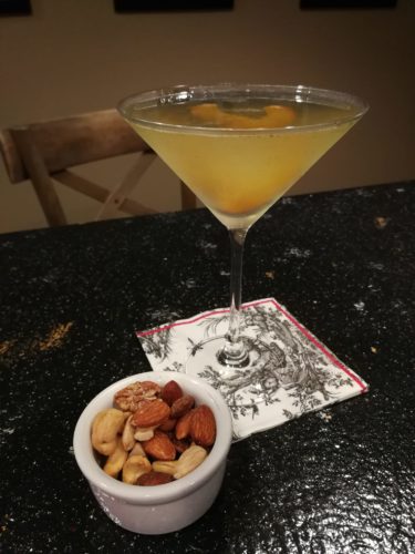 Peach Basil Martini served with mixed nuts