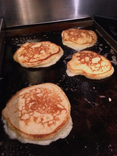 Fluffy buttermilk pancakes on the griddle