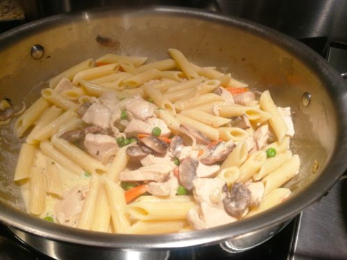 Add cooked penne to the creamy chicken sauce