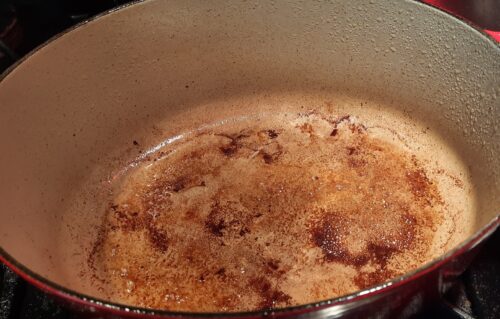 The browned bits in the pot